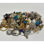 A large collection of costume jewellery including paste pearl necklaces, bead necklaces, enamelled