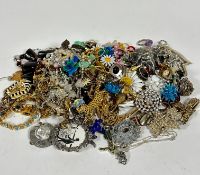 A large collection of costume jewellery including paste pearl necklaces, bead necklaces, enamelled