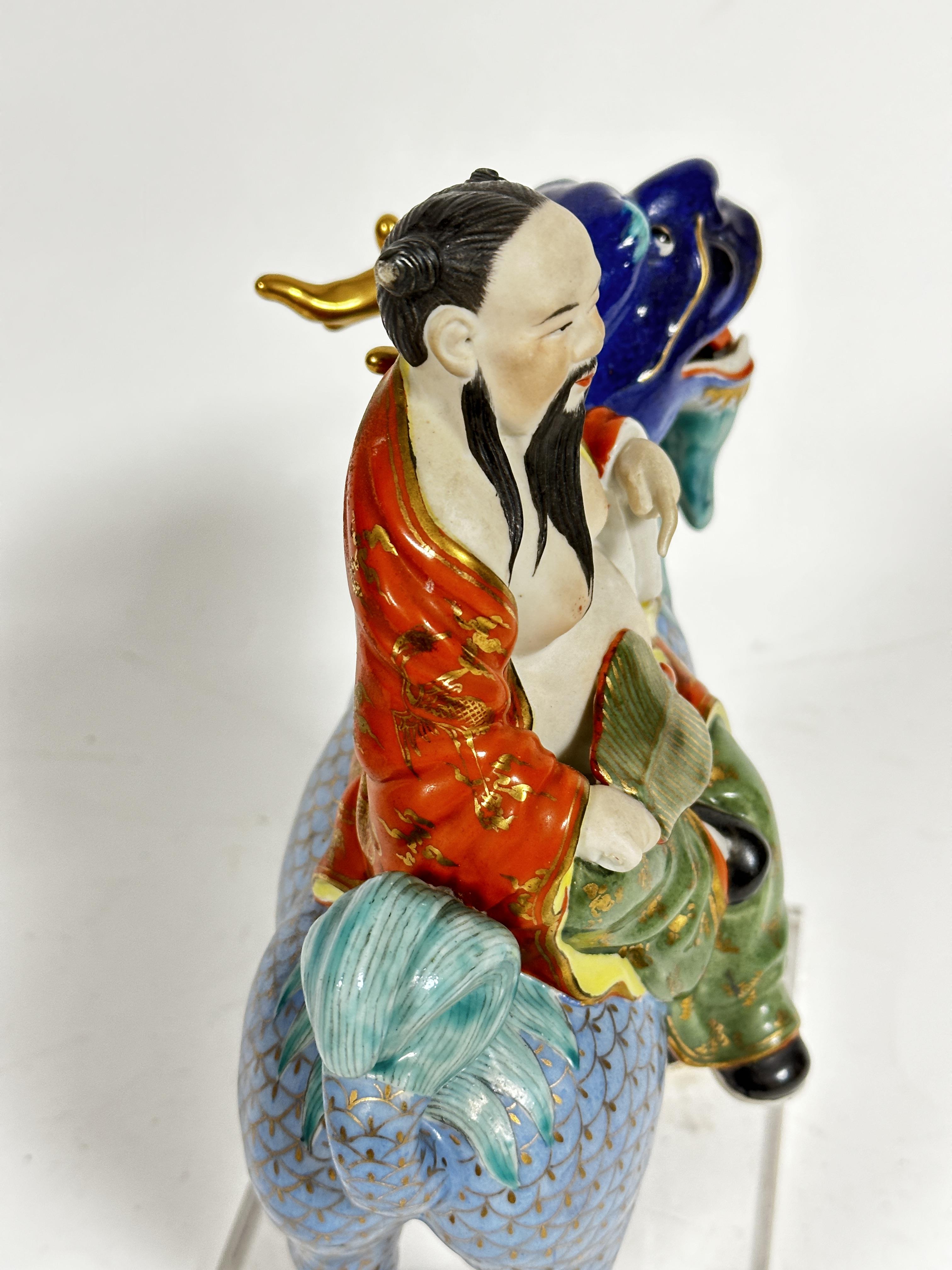 A Japanese porcelain figure of a dignitary with fan, seated on a deer, mounted on plastic base, (7cm - Image 2 of 6