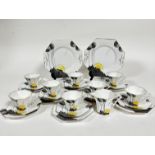 A Melba bone china Art Deco twenty eight piece tea service including two octagonal cake plates,