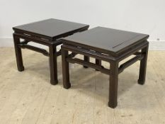 A pair of Chinese rosewood lamp tables, each with panelled top raised on shaped supports, H52cm,