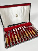 A set of six pairs of horn handled Epns steak knives and forks in original fitted case marked Samuel