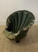 An unusual late 19th/ early 20th century club chair, formed as a shell, raised turned front supports