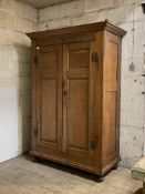 A late 18th century country oak hanging cupboard, moulded cornice over lunette carved frieze, two