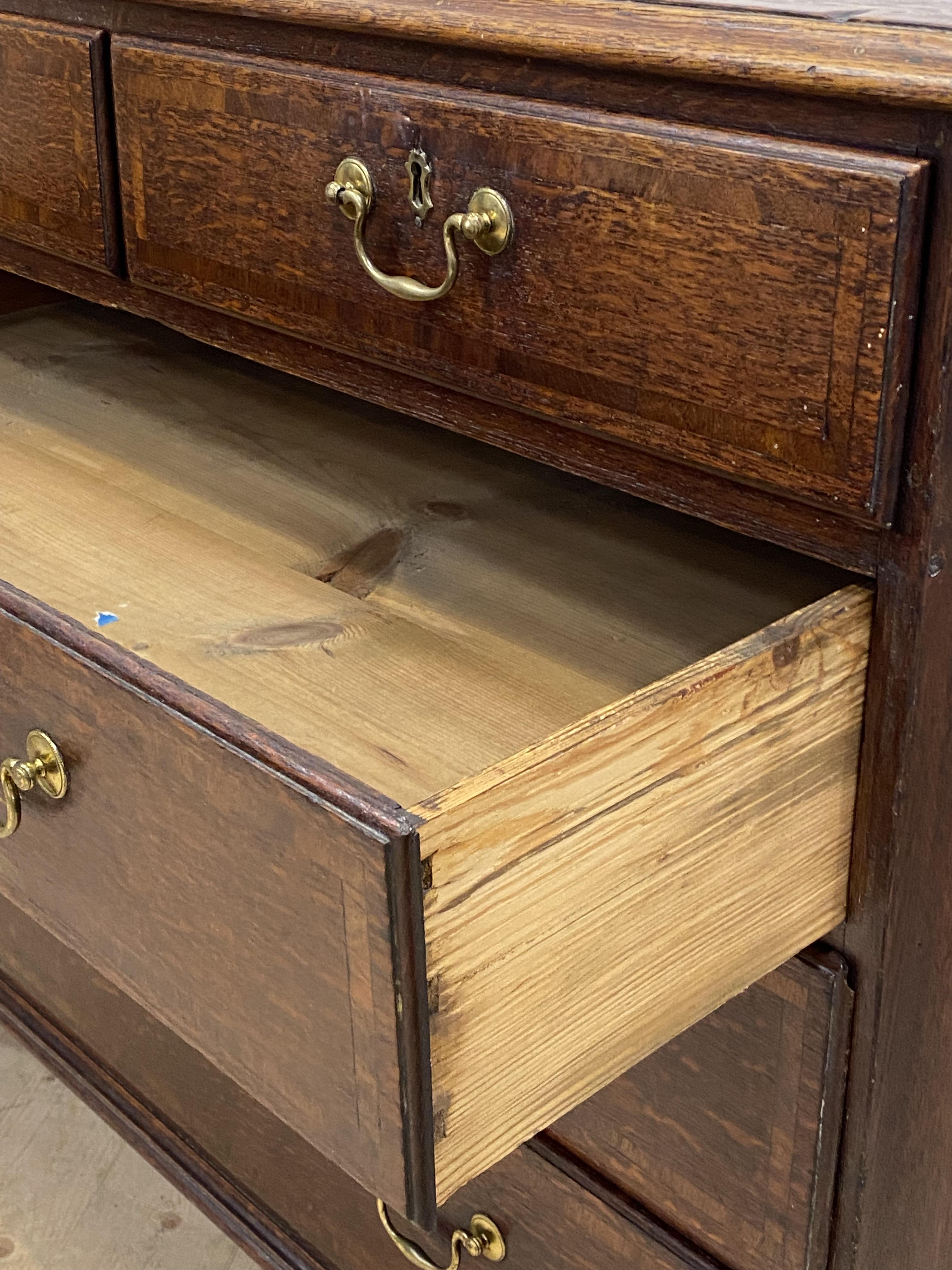A George III oak chest, mahogany cross banded top and two short and three long graduated drawers, - Image 4 of 4