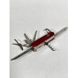 A Victronox Swiss stainless steel Officer Suisse pen knife complete with tweezers, screwdriver,