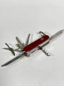 A Victronox Swiss stainless steel Officer Suisse pen knife complete with tweezers, screwdriver,