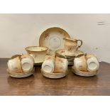 An Edwardian china tea service, comprising twelve cups and saucers, twelve side plates, two