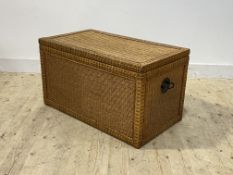 A wicker blanket box, hinged lid opening to plain interior, carry handle to each end h52cm w92cm