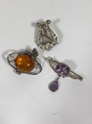 An amethyst set white metal bar brooch with pear cut drop, together with two white metal brooches (
