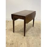 An early 19th century mahogany Pembroke table, with drawer to one end, raised on square tapered