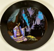 A 1920s ebonised circular framed panel with butterfly wings depicting a Japanese figure with pagodas