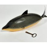 A treen painted fish motorised fish with articulated tale, complete with key and inset glass eyes