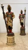 A matched pair of Moorish figural uplighters, moulded fibreglass in opposing positions holding