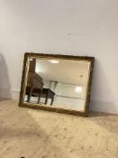 An early 20th century gilt composition framed wall mirror with bevelled plate 72cm x 94cm