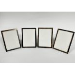 A set of four sterling silver rectangular photograph frames with plush mounted backs, (aperture 17.