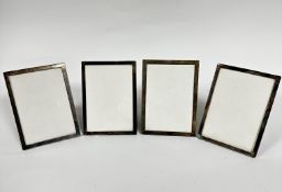 A set of four sterling silver rectangular photograph frames with plush mounted backs, (aperture 17.