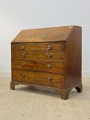 A George III mahogany bureau, fall front with fitted interior, over four long graduated drawers,