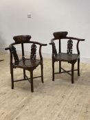 A pair of Chinese rosewood corner chairs, with carved splats, panel seats, standing on turned