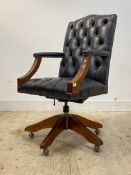 A Gainsborough style swivel desk chair, the buttoned and studded faux leather upholstered back