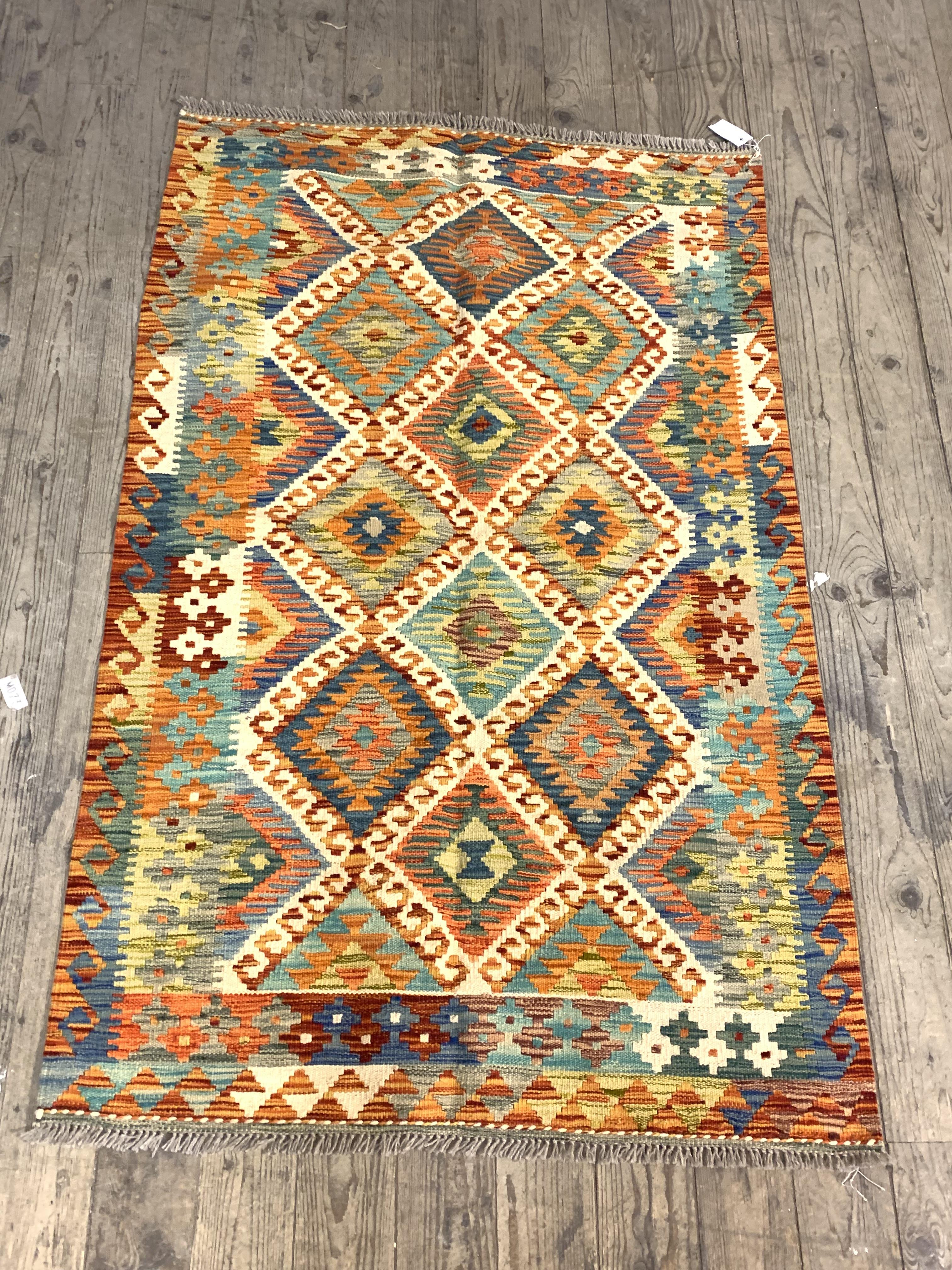 A Chobi kilim rug of typical design and palette 153cm x 57cm