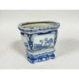 A modern Chinese blue and white oval panel sided plant pot complete with stand with stylised