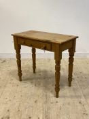 A Victorian style pine side table with frieze drawer, raised on turned supports, H77cm, W86cm,