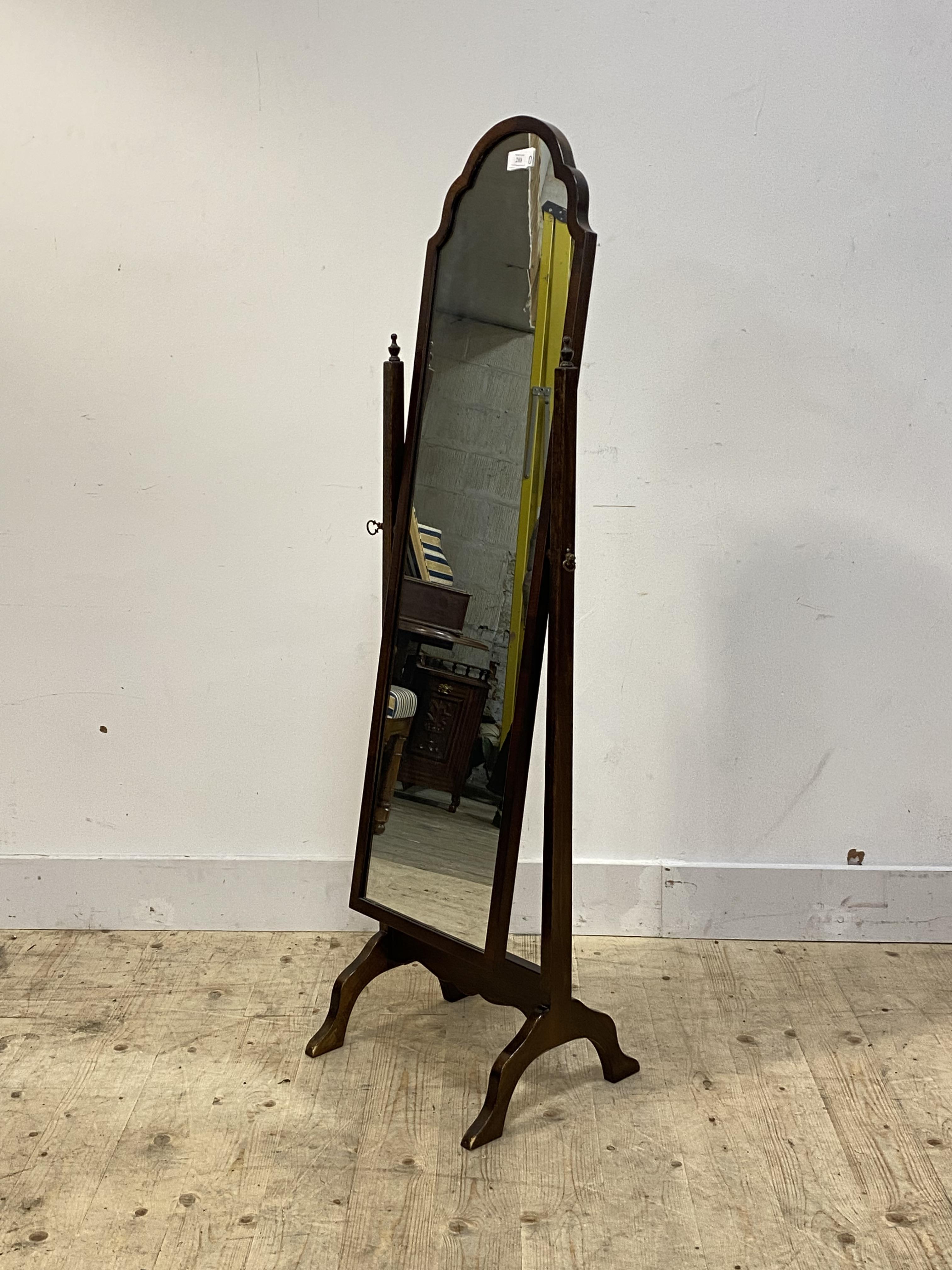 An 18th century design walnut framed cheval mirror, the arched plate swivelling between square