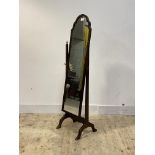 An 18th century design walnut framed cheval mirror, the arched plate swivelling between square