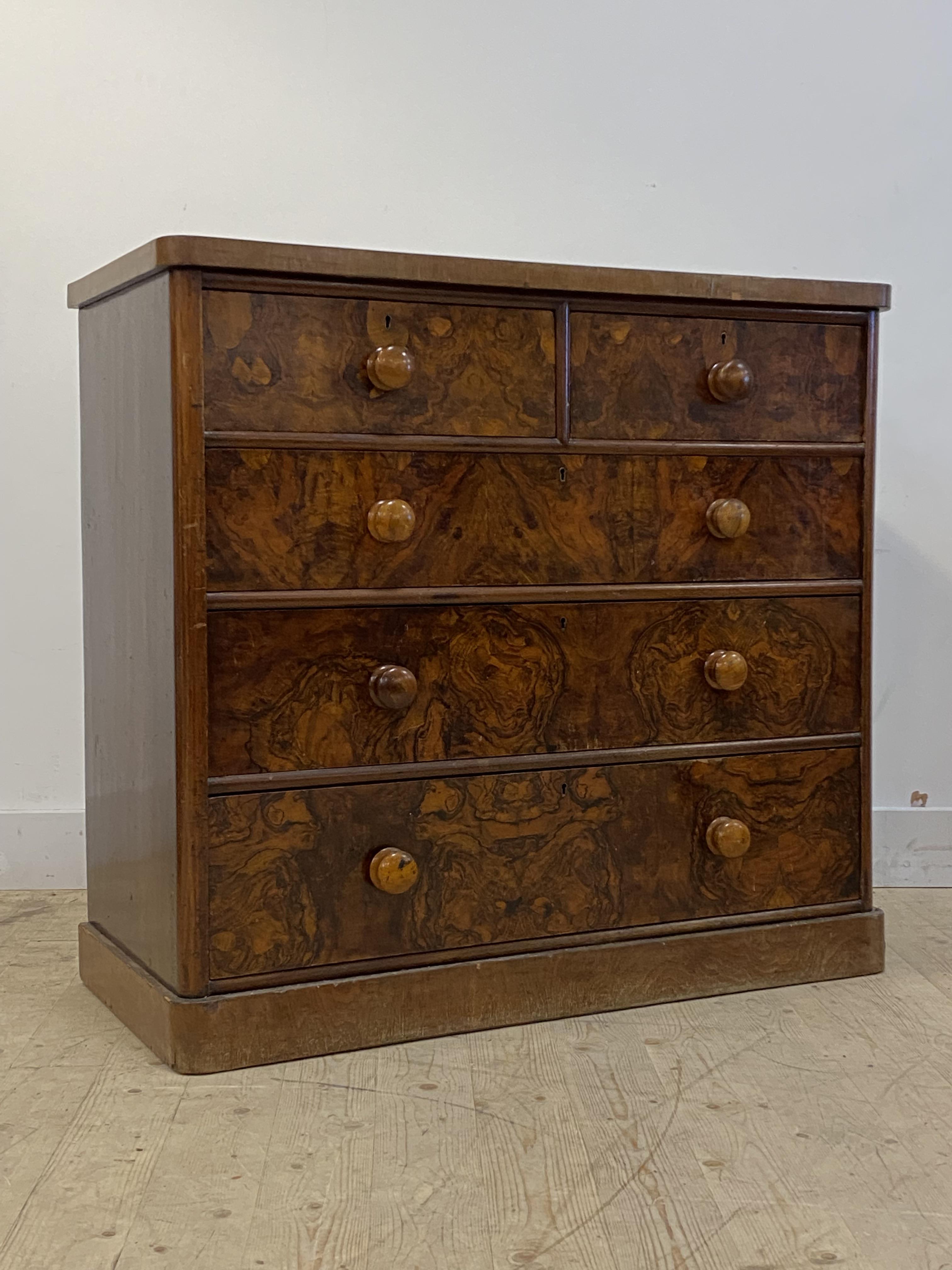A Victorian figured walnut chest, fitted with two short and three long graduated drawers, plinth