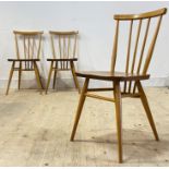 Ercol, a set of three vintage elm and beech comb back dining chairs, raised on turned supports, (h