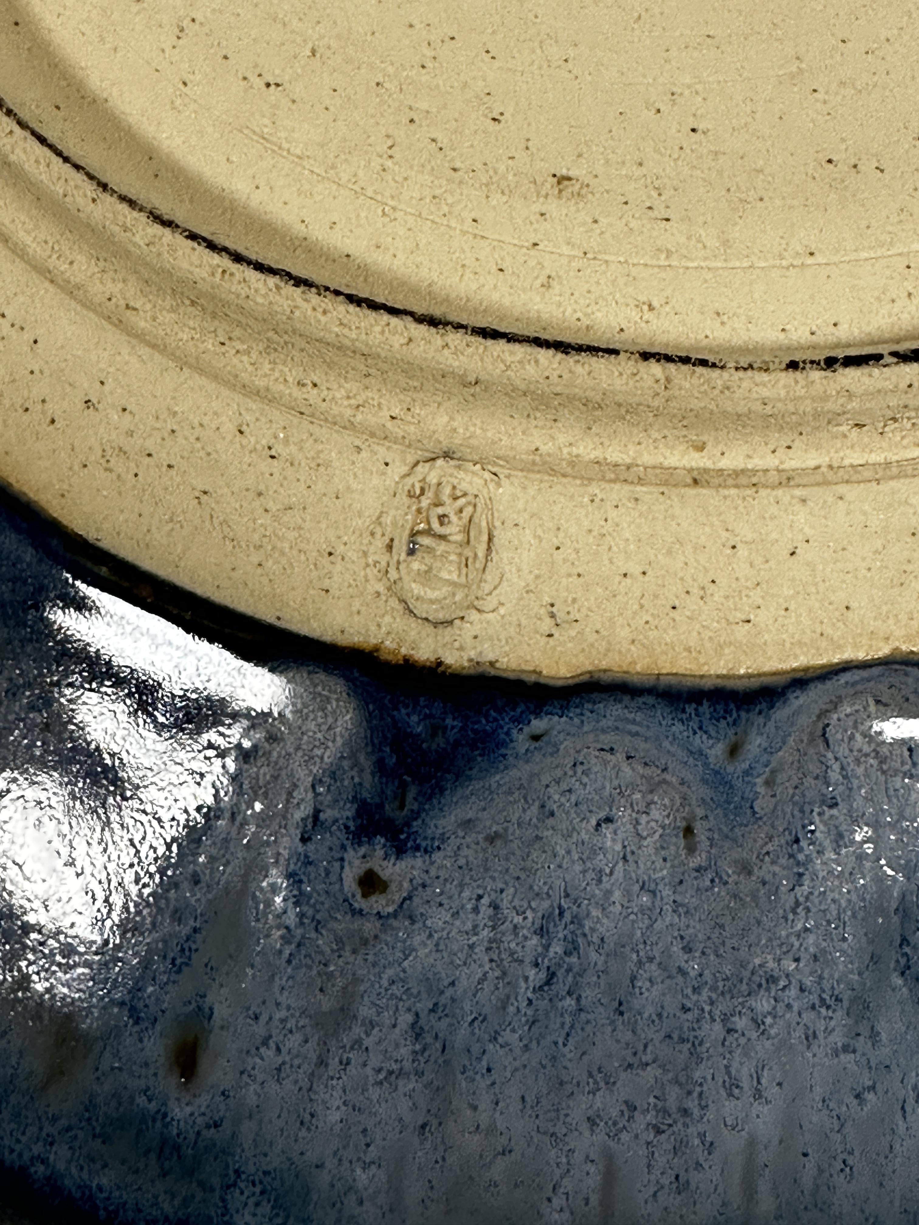 A pottery circular dish decorated with spiralling brown pale blue and turquoise blue glaze, with - Image 2 of 4