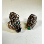 A Chinese white metal chased dragon's head ring with inset turquoise eyes and black quartz pearl