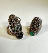 A Chinese white metal chased dragon's head ring with inset turquoise eyes and black quartz pearl