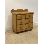 A Victorian style pine chest, ledge back over two short and two long drawers, bun supports,