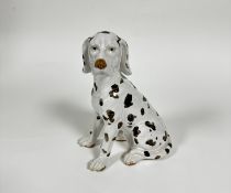 A pottery figure of a Dalmatian figure, unmarked, (h 30cm x 23cm x 13cm)