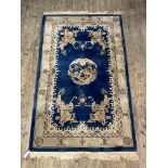 A Chinese washed wool pile rug, the blue ground with medallion within an ivory border 152cm x 270cm