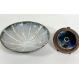 A Japanese pottery dish decorated with radiating white lines with pale blue and grey panels and
