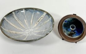 A Japanese pottery dish decorated with radiating white lines with pale blue and grey panels and