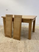 A solid oak extending dining table, H79cm, W90cm, L132cm/162cm