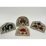 A group of four Kashmiri white felted wool tea cosy's of arched and shaped design with lotus flower,