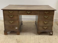 An early 19th century mahogany partners desk, each side fitted with one long and seven short