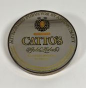 A decorative "Catto's Gold Label Scotch Whiskey 86" circular gold enamelled mirror ( l - 30.5cm w-