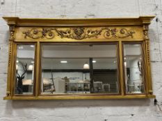 A gilt composition framed over mantel mirror of Neoclassical design, the frieze with scrolling