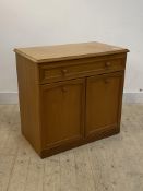 A mid century teak side cabinet, with drawer over twin cupboard doors enclosing a shelf, H77cm,