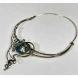 A silver Art Nouveau style necklace with hinged loop to back, set with enamel oval panel of