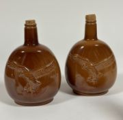 A pair of brown ceramic Carlton Ware for Beneagles scotch whisky decanters embossed with an Osprey