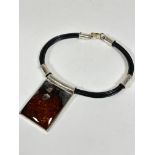 A Polish amber thong and silver mounted collar style necklace with clip in fastening