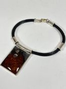 A Polish amber thong and silver mounted collar style necklace with clip in fastening