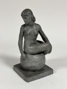 Evelyn Cheape, (1957) a plaster cast of a naked figure seated on ball on square moulded base, with